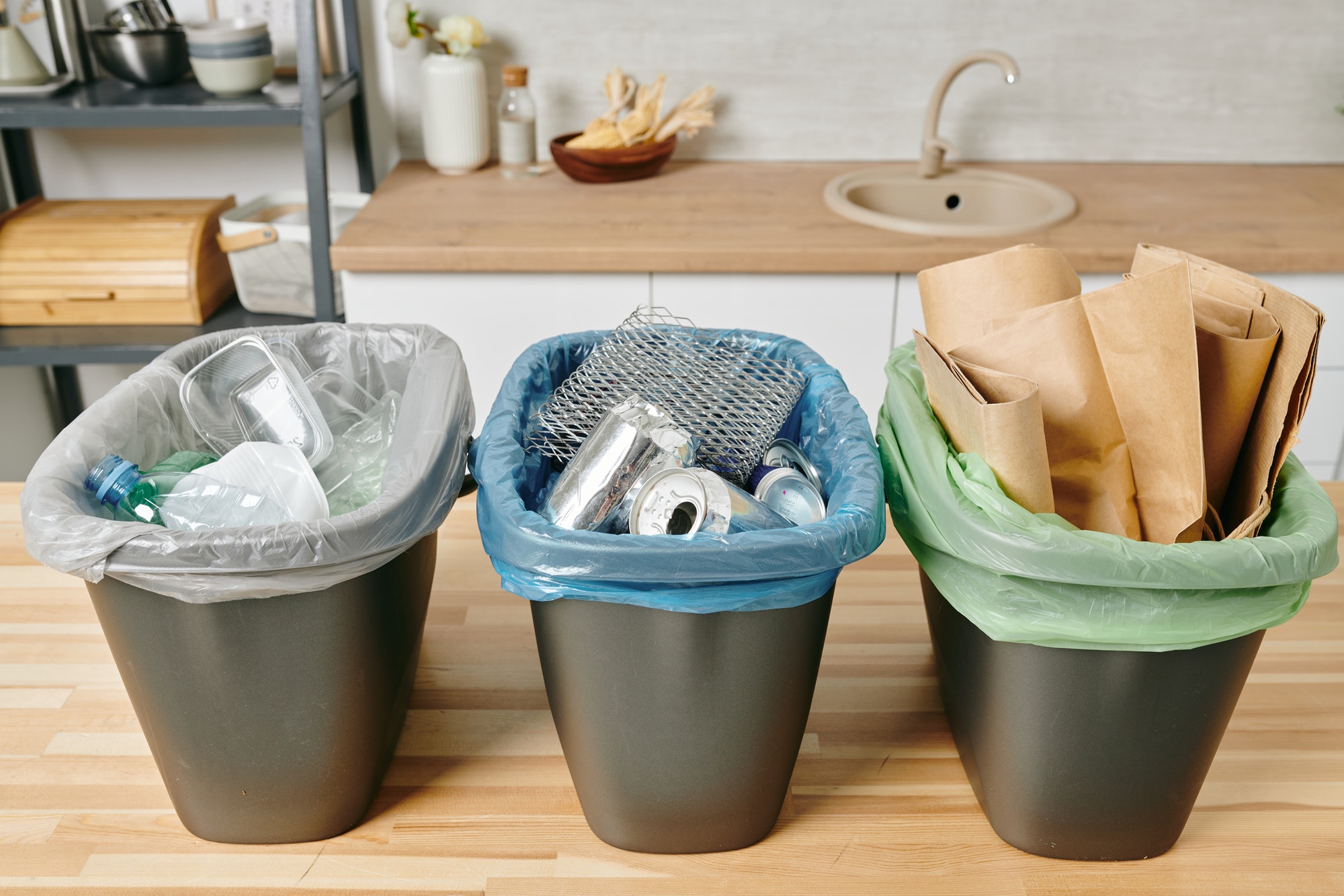 Row of three trash bins with sorted garbage